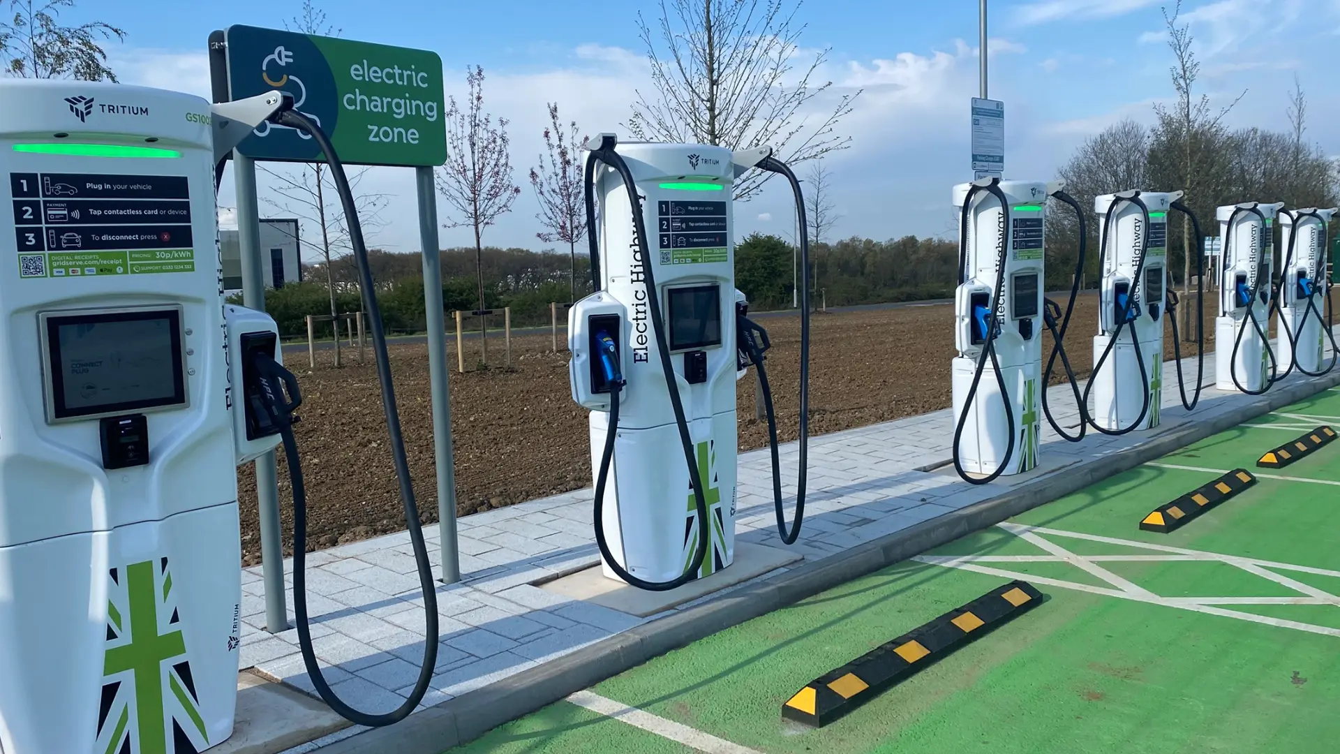 Row of rapid electric vehicle chargers at a public charging hub