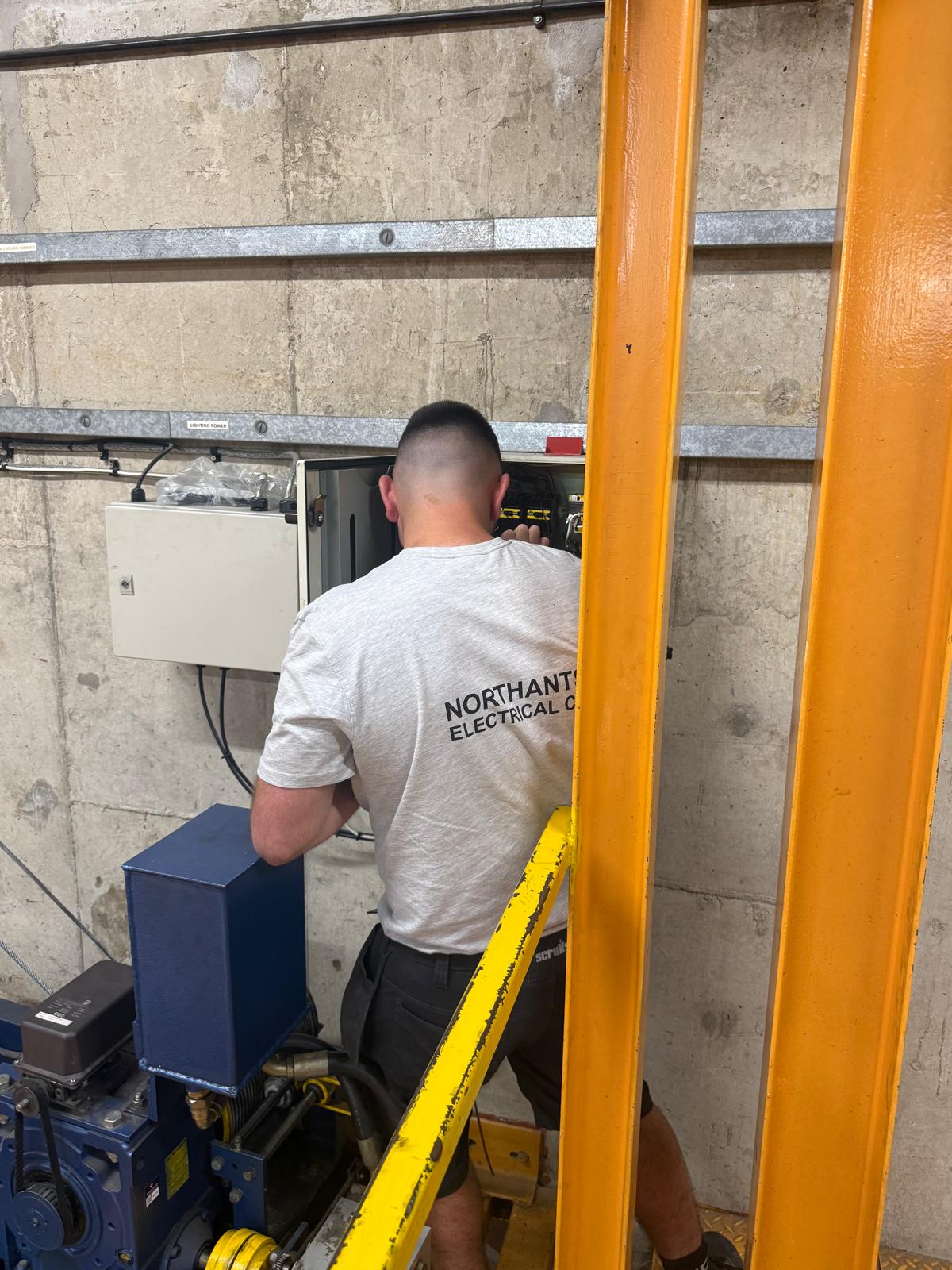 Engineer working at a theatre control panel during out of hours electrical repairs
