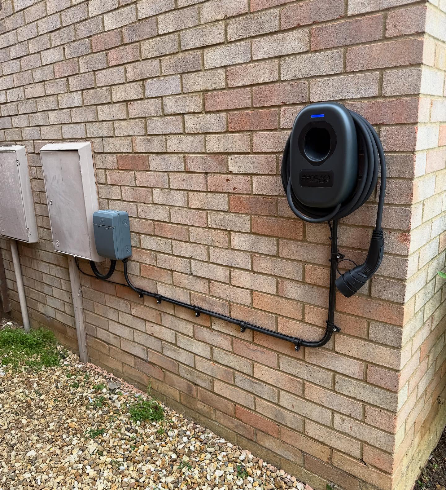 EV charger with isolator and external conduit run installed on a house