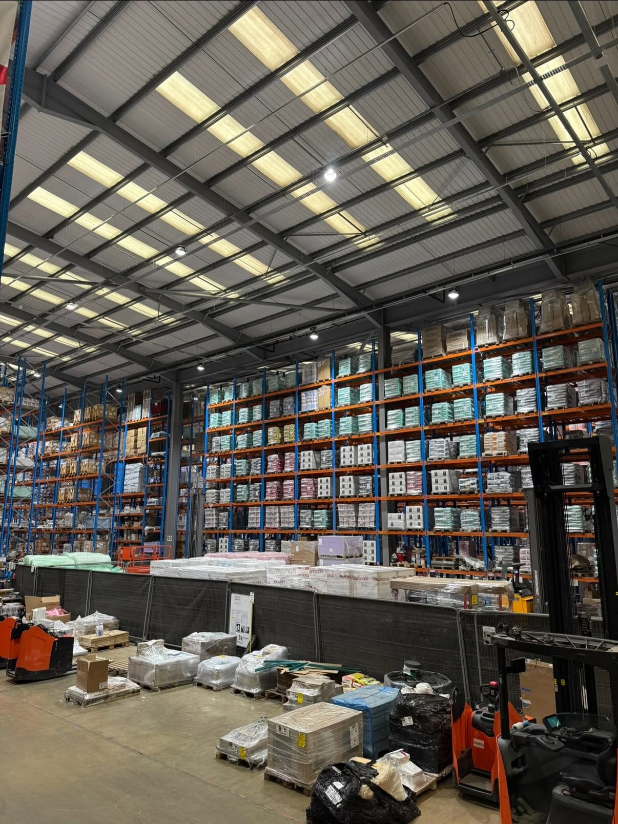 High bay and panel lighting installed over racking in a Northamptonshire warehouse