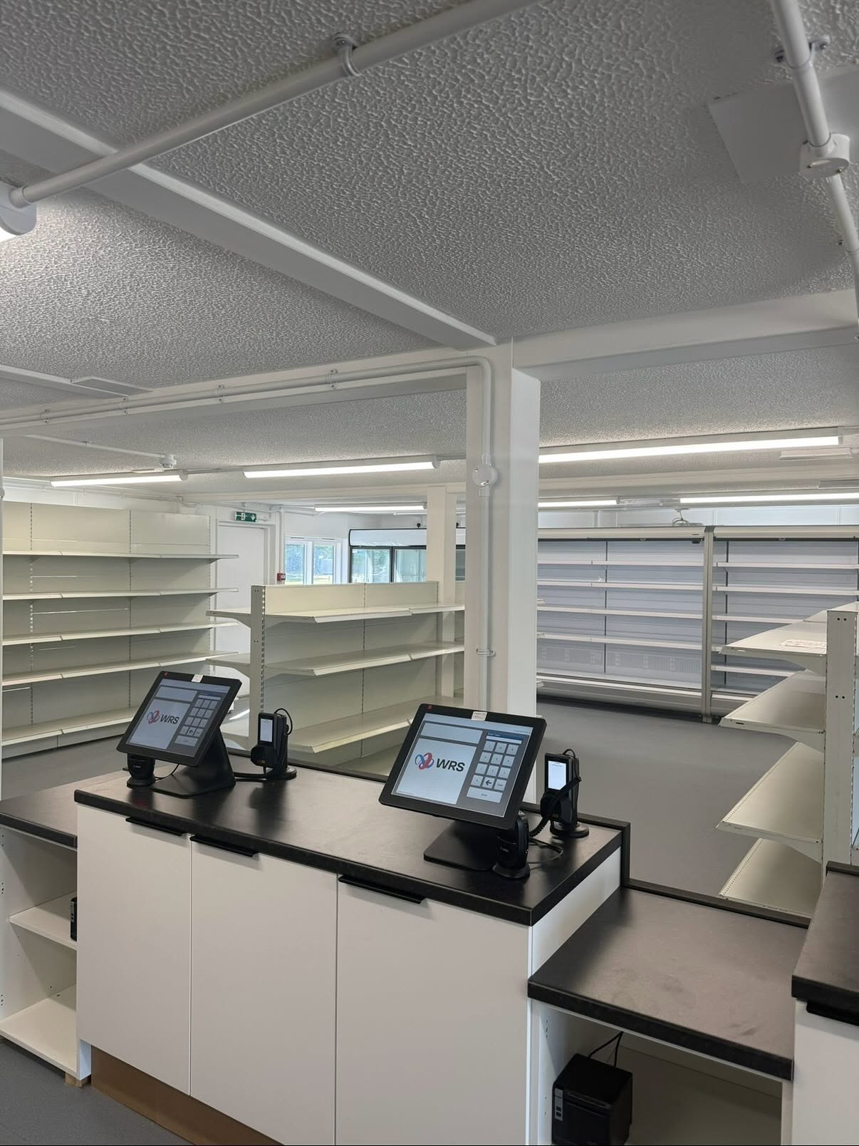 Finished convenience store interior in Northampton with tills, chilled units and commercial lighting