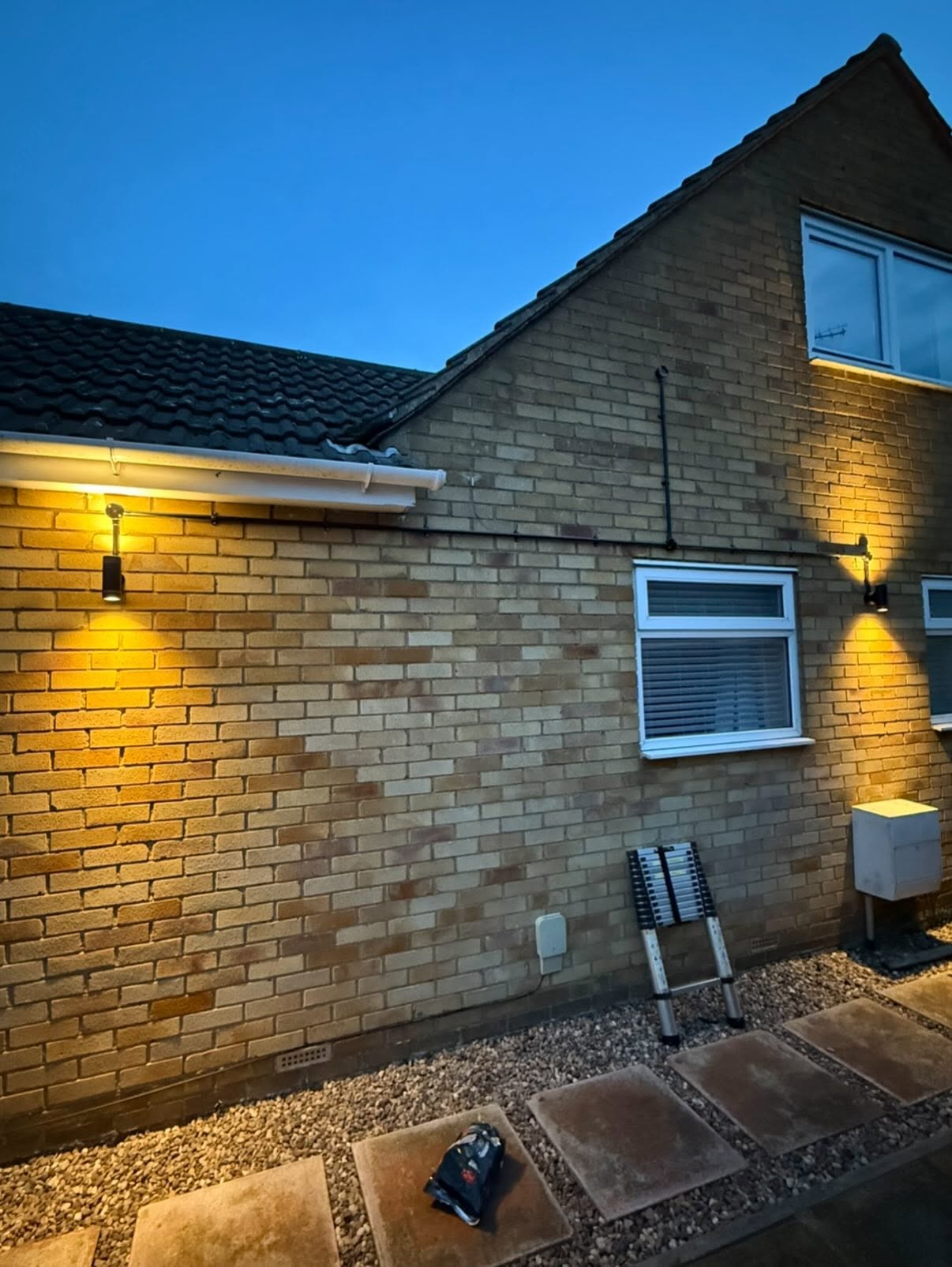 External wall lights on a house at dusk installed with a lux sensor