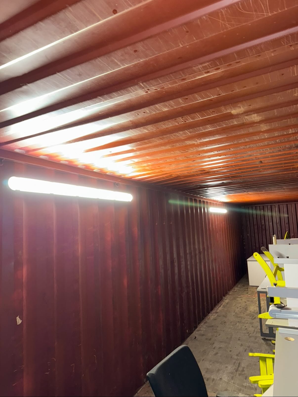 Batten lighting installed inside a converted container at a rural business park
