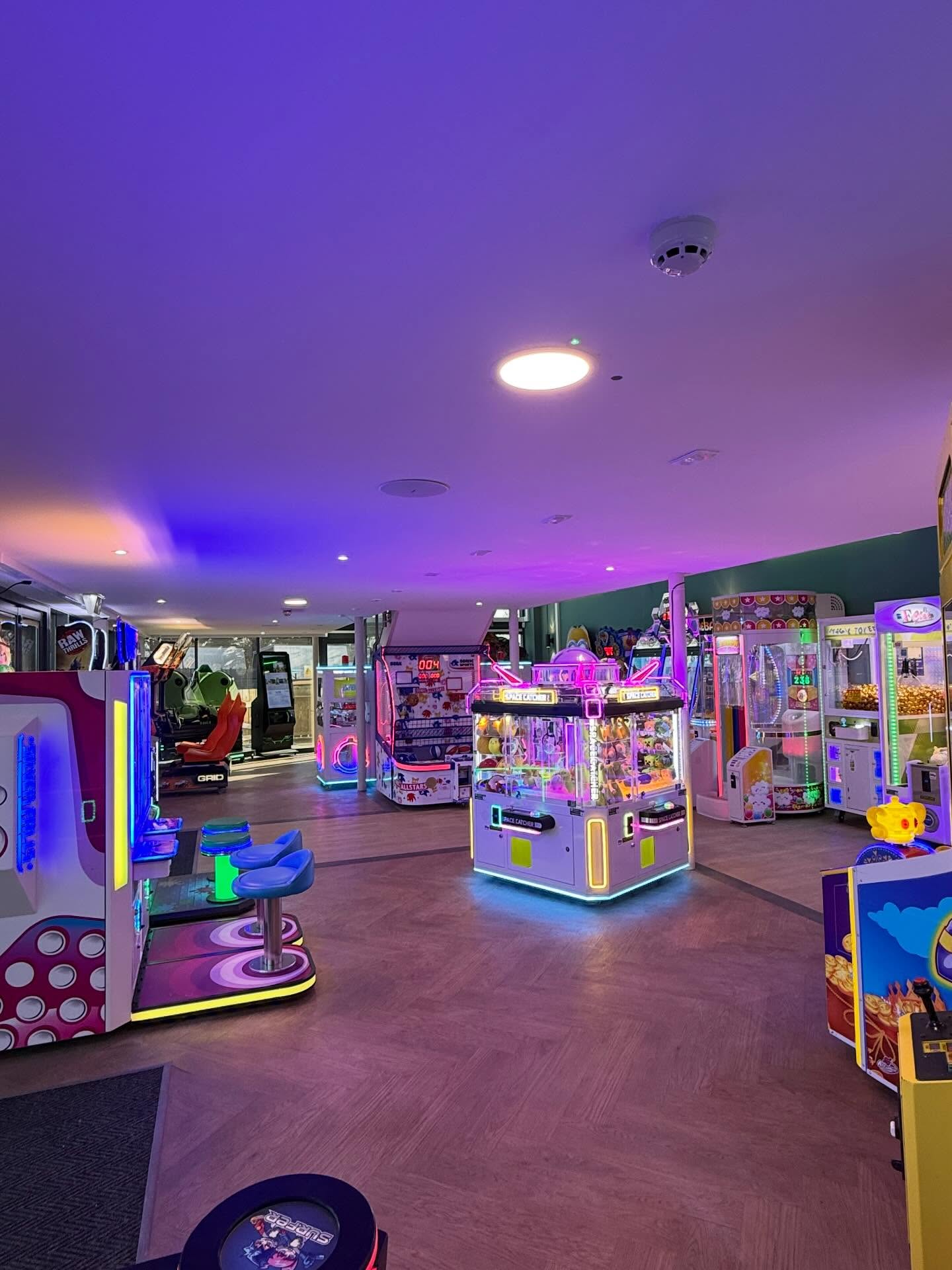 Amusement arcade floor with machines supplied and the purple lighting scheme installed