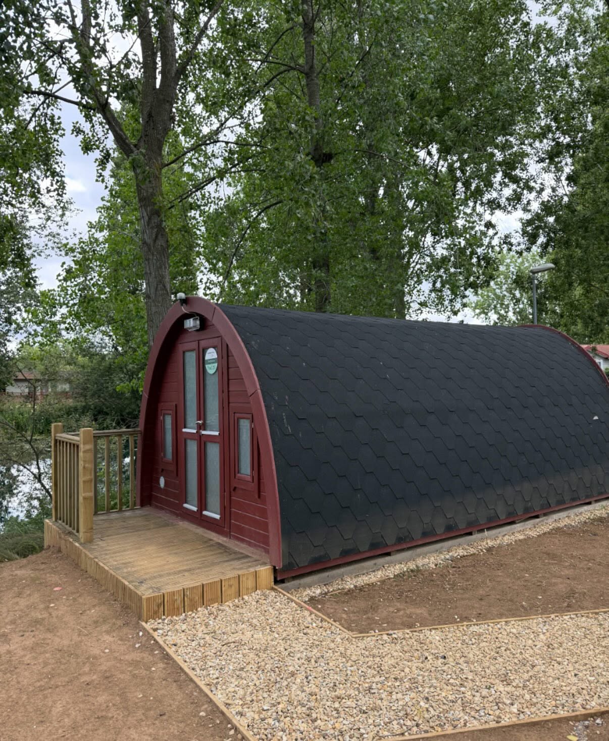 Finished glamping pod exterior with external lighting installed at a Northamptonshire lakeside site