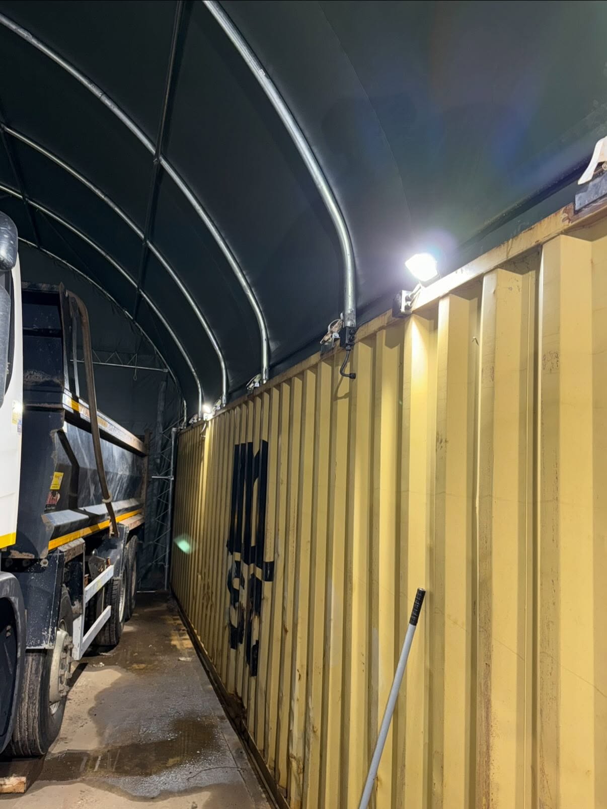 Floodlighting installed on a container at a Northamptonshire yard, photographed at night